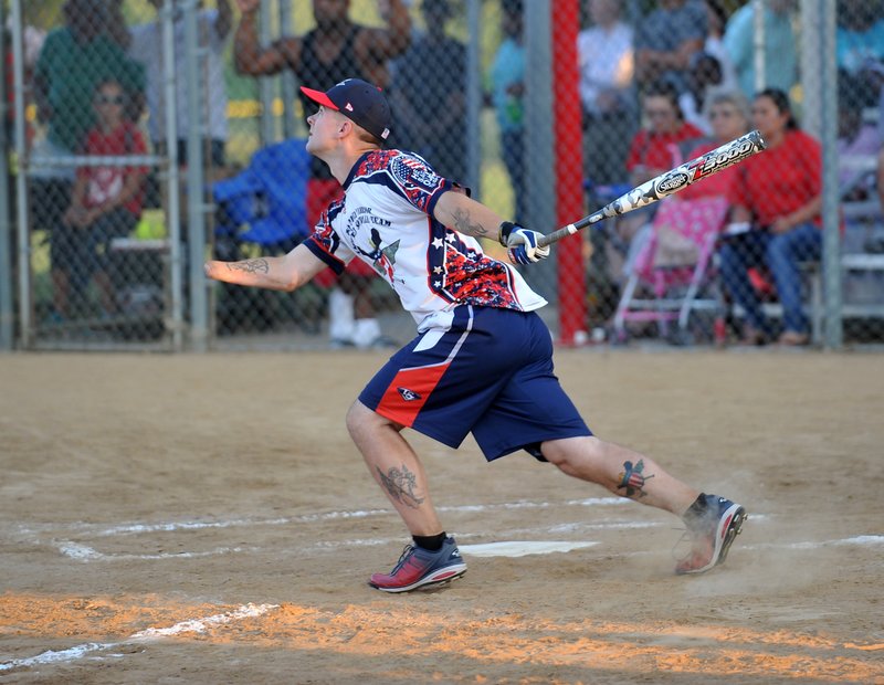 Kyle Earl, Wounded Warrior amputee softball player, connects Friday for a base hit during their softball game against the Tyson All Stars at the Tyson Sports Complex in Springdale. For photo galleries, go to nwadg.com/photos.