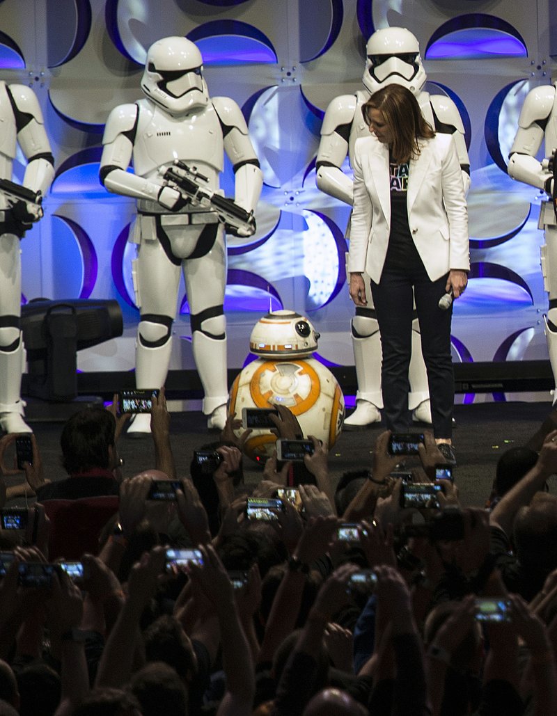 In this April photo, producer Kathleen Kennedy (right) looks down at the BB-8 droid during the Star Wars Celebration at the Anaheim (Calif.) Convention Center. The spherical droid will be featured in December's "Star Wars: The Force Awakens."