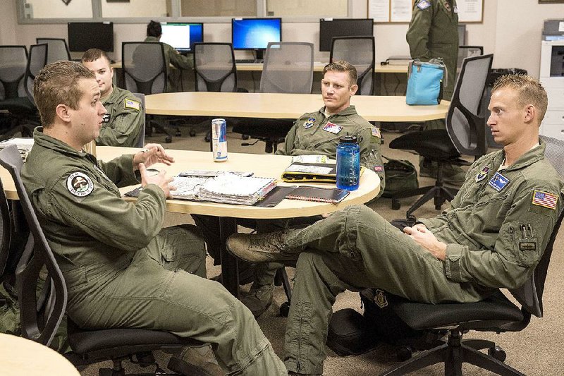 Senior Airman Daniel Tremblett (left) of the 328th Airlift Squadron, 914th Airlift Wing, Niagara Falls Air Reserve Station, is trained by Tech Sgt. Mitch Hal (center) of the 189th Airlift Wing’s 154th Training Squadron, and Staff Sgt. Brittan Hahn of the active duty 314th Airlift Wing’s 62nd Airlift Squadron at Little Rock Air Force Base in Jacksonville.