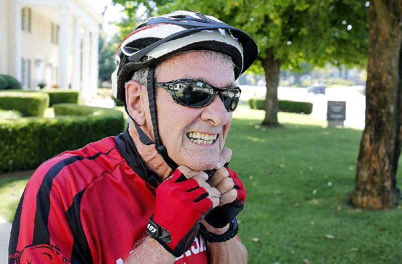 Dan Ferritor, 75, the interim chancellor at the University of Arkansas, arrives by bicycle on the campus in Fayetteville on Aug. 7. Ferritor, an avid cyclist, said he plans to ride to work two or three days a week. 