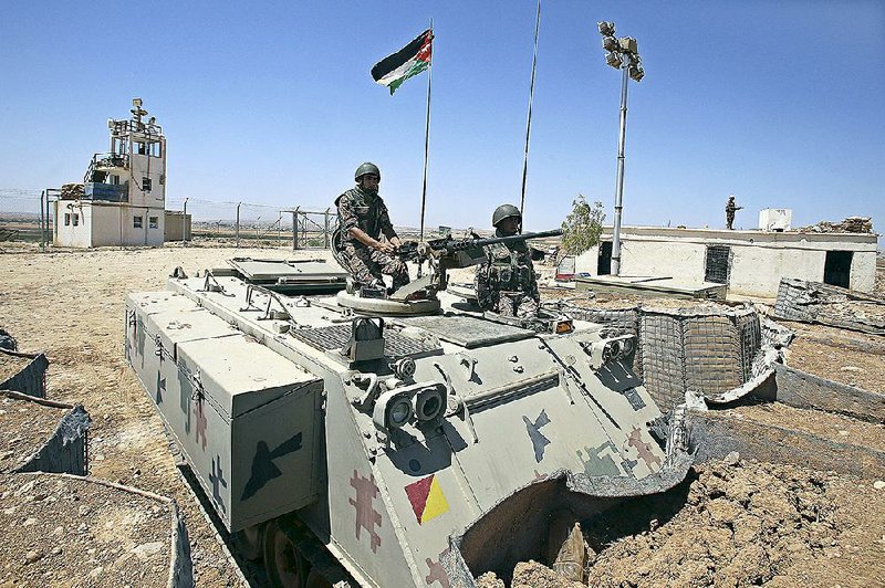 Jordanian soldiers stand guard in Mafraq, Jordan, near the Syrian border Sunday.