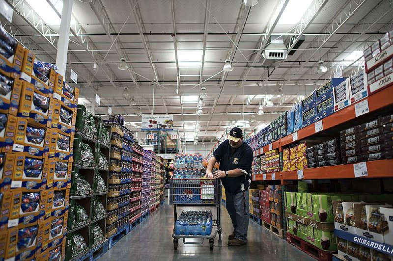 A shopper selects items to restock a school’s concession stand at a Costco Wholesale Corp. store in East Peoria, Ill. The company hopes to open its first store in France in the spring.