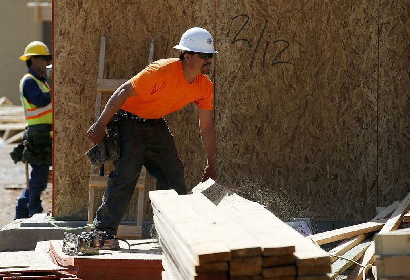 Workers build a new apartment complex in Scottsdale, Ariz., in this April file photo. Confidence among homebuilders rose in August, a sign the residential real estate market is improving.