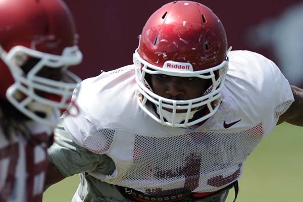 Arkansas defensive lineman DeMarcus Hodge takes part in a drill Thursday, Aug. 13, 2015, during practice at the university practice field in Fayetteville.