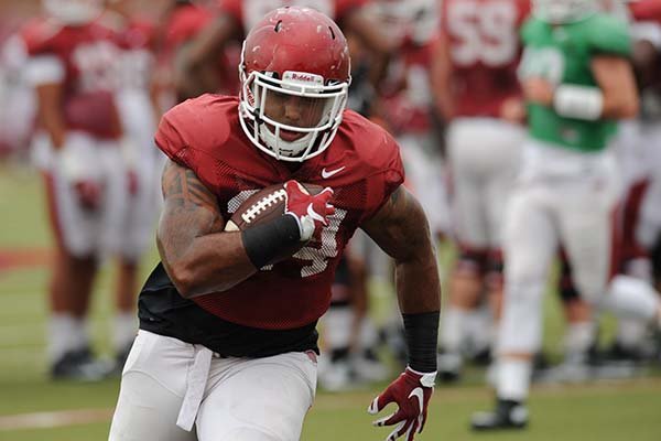 Arkansas running back Kody Walker carries the ball Tuesday, Aug. 18, 2015, during practice at the university's practice field in Fayetteville.