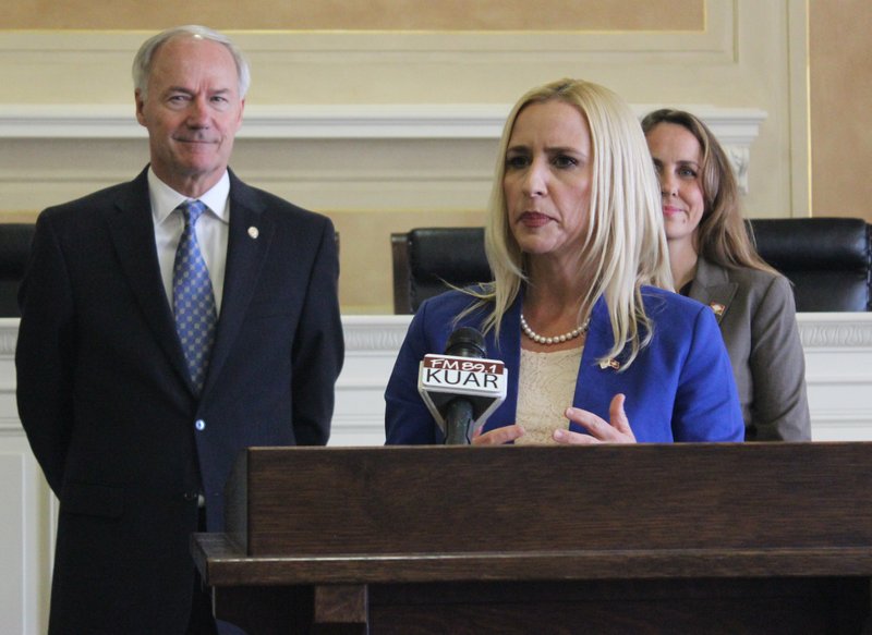 Arkansas Attorney General Leslie Rutledge speaks Tuesday, Aug. 18, 2015, about a new federal-state partnership program that will identify and investigate disability benefits fraud. Looking on are Arkansas Gov. Asa Hutchinson and state Sen. Missy Irvin, R-Mountain Home.