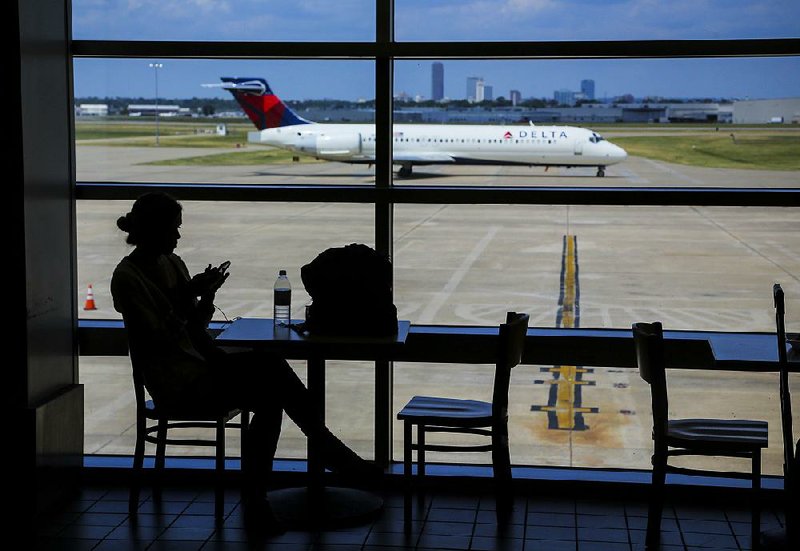 Kaitlin Bonney of Greensboro, N.C., waits for her flight Tuesday at Little Rock’s Bill and Hillary Clinton National Airport/Adams Field.