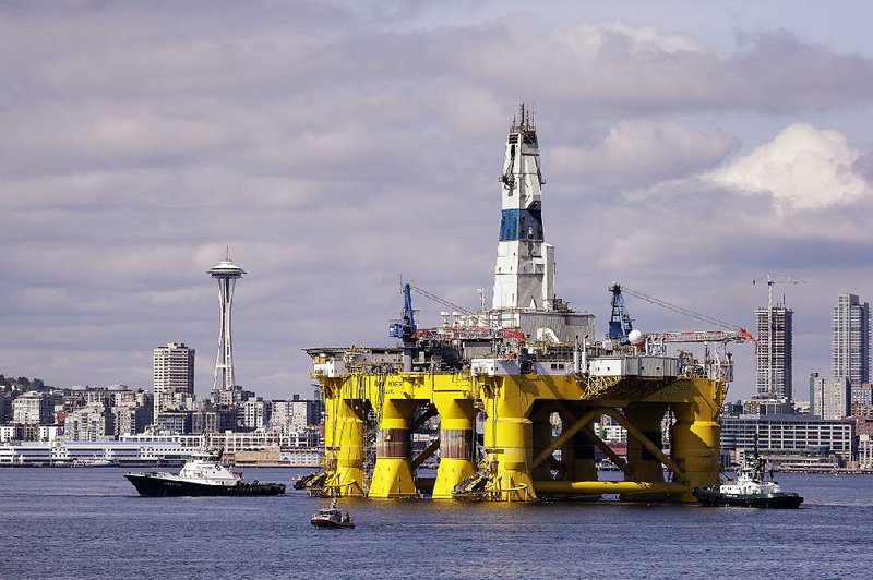 The oil drilling rig Polar Pioneer is towed toward a dock in Elliott Bay in Seattle in May. The rig is the first of two drilling rigs Royal Dutch Shell is outfitting for Arctic oil exploration.