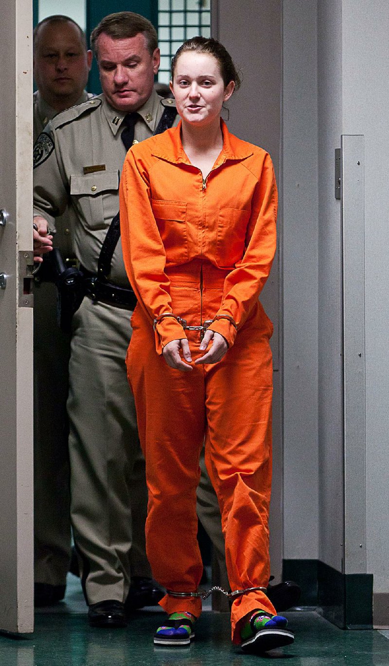 Jaci Jackson is led to a Columbia County courtroom in Magnolia on Dec. 7, 2011, where she faced charges of stealing five horses from Southern Arkansas University. 