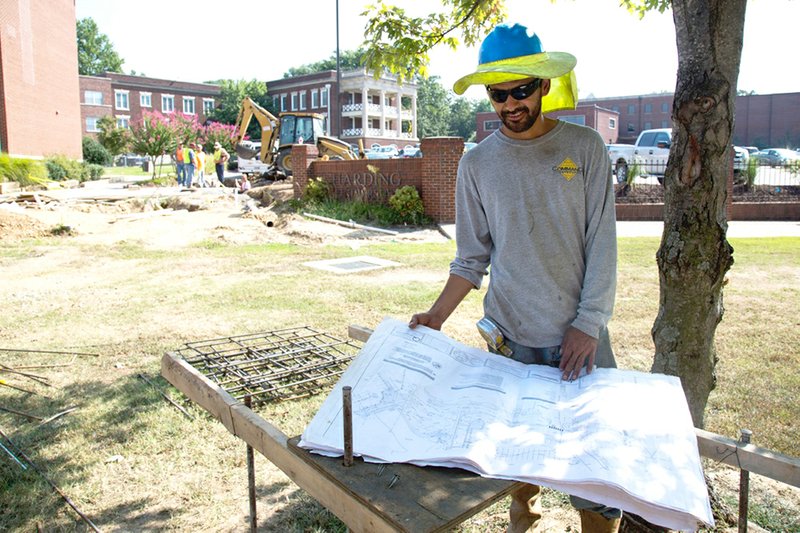 Jose Mendoza, field superintendent with Command Construction, looks over plans at the site of Harding University’s First Ladies Garden. The project is expected to be finished before homecoming this fall.