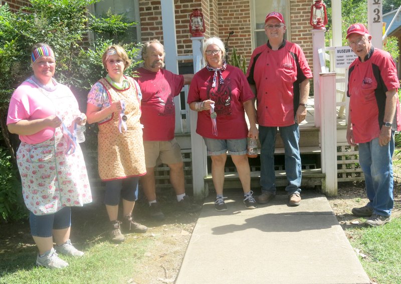 Photo by Susan Holland Overall winners in the third annual Gravette Day Dutch oven cook-off were Barnyard Cooks (left), Lincoln, third place; Backwoods Bakers, Fayetteville, second place; and Swifty Creek Cookers, Sarcoxie, Mo., first place.