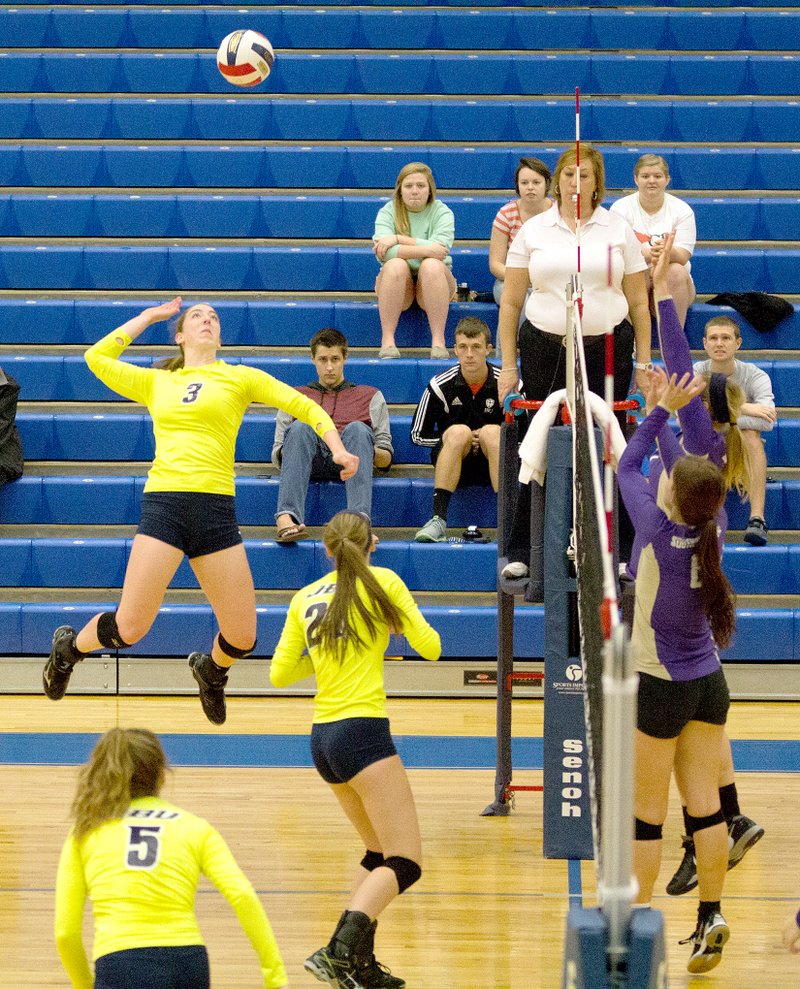 Photo courtesy of JBU Sports Information John Brown University outside hitter Audrey Dearien goes high into the air for a hit during a match last season. Dearien, a first-team All-Sooner Athletic Conference player and honorable mention NAIA All-American, led JBU with 416 kills in 2014.