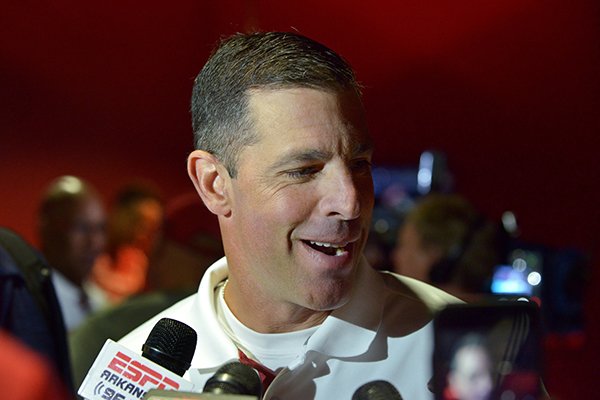 Dan Enos, Arkansas' offensive coordinator, speaks to the media on Sunday, Aug. 9, 2015, during Arkansas football media day at the Fred W. Smith Football Center in Fayetteville.