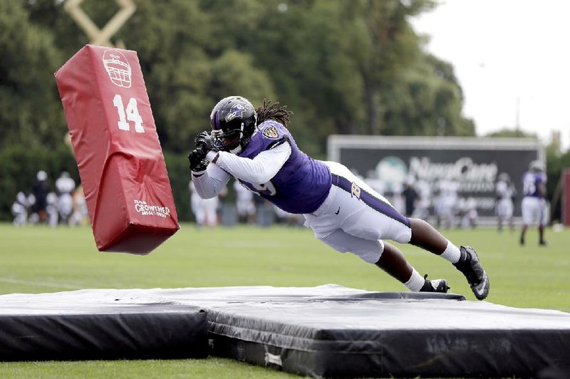 Out of the way, dummy Baltimore Ravens offensive guard Leon Brown, a rookie from Alabama, hits a blocking dummy in a drill during Wednesday’s training camp workout in Philadelphia. The Ravens were practicing against the Philadelphia Eagles, whom the Ravens will face in an exhibition game Saturday. 