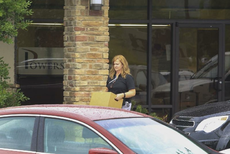 Agents with the federal Office of the Inspector General converged on Powers of Arkansas, 5440 NorthShore Drive in North Little Rock, on Wednesday. They removed several boxes of items. 