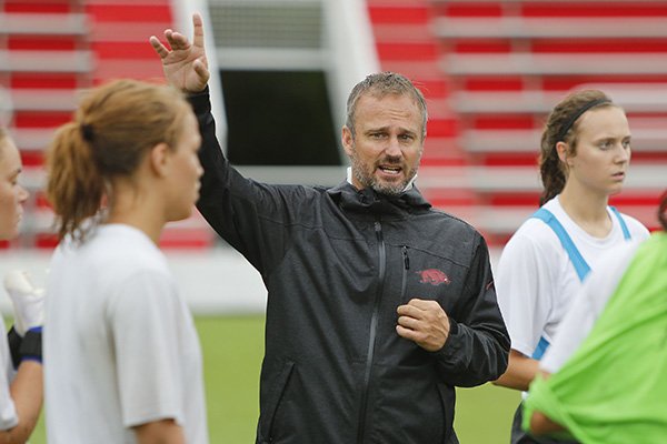 Arkansas coach Colby Hale talks to his team during practice, Wednesday, Aug. 19, 2015, at Razorback Field in Fayetteville. 