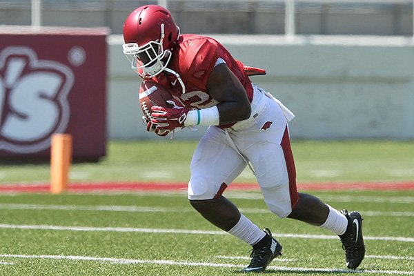 Arkansas running back Rawleigh Williams carries the ball Saturday, Aug. 15, 2015, during practice at Razorback Stadium in Fayetteville. 