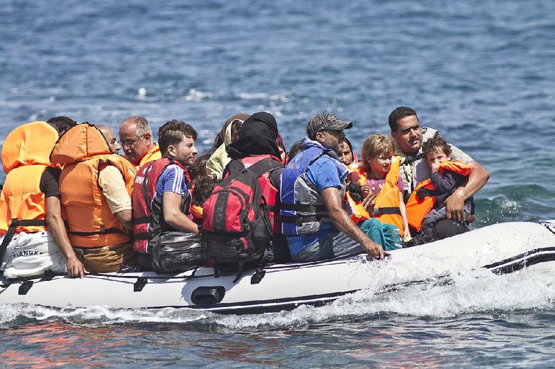 Syrian migrants arrive on a dinghy Thursday to the village of Skala Sikaminea on the island of Lesbos, Greece. 