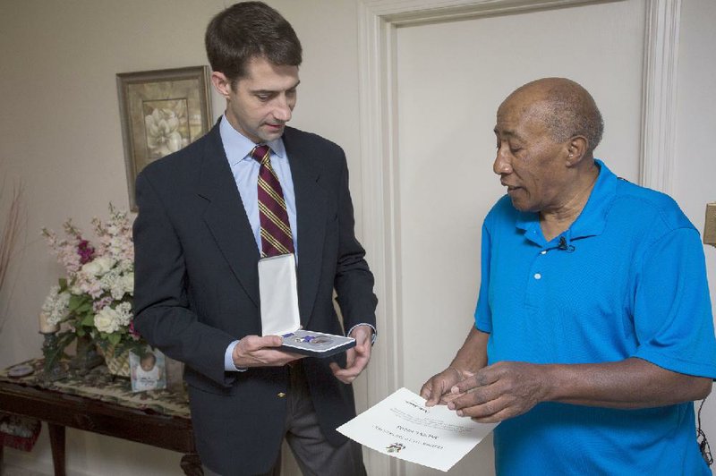 U.S. Sen. Tom Cotton, R-Ark., presents Melvin Fields, 68, of Pine Bluff with the Purple Heart on Thursday for injuries he suffered during Army service in Vietnam in 1968. 