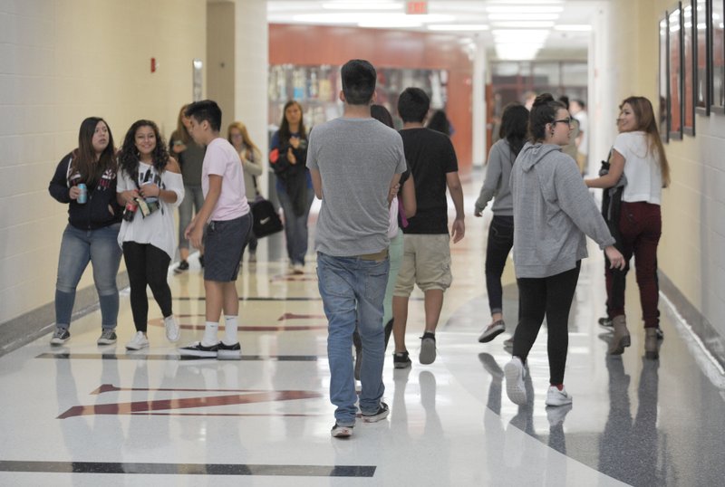 NWA Democrat-Gazette/ANDY SHUPE Students walk Thursday through the halls during a class change at Springdale High School. Police added extra patrols at the school Thursday and a shooting incident Wednesday, said Mike Peters, acting police chief.