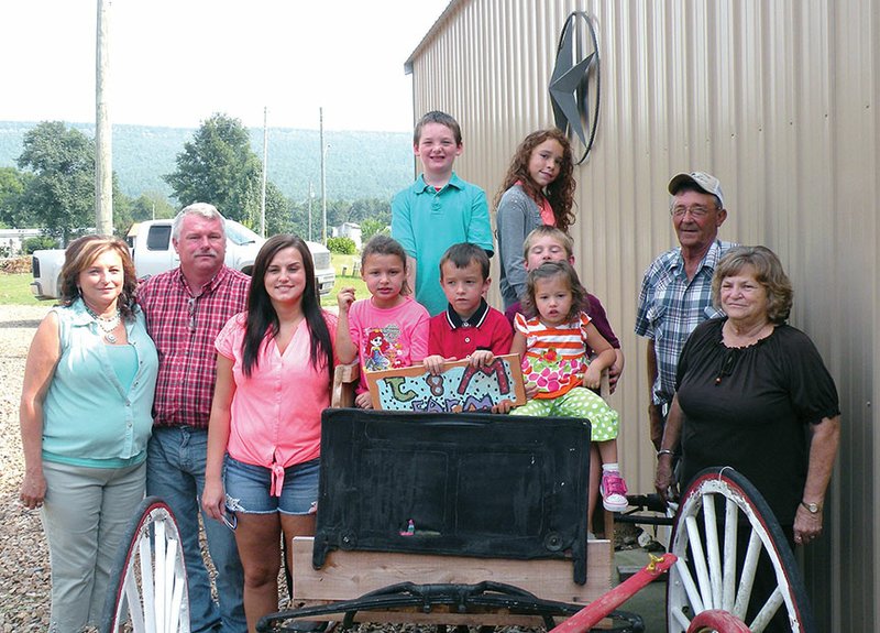 Mariea and James Harvey, far left, are the 2015 Perry County Farm Family of the Year. Their family includes their daughter Katesha Abernathy, standing, third from left; the Harveys’ grandchildren, sitting in the wagon, Kyra McGehee, Kymper Abernathy and Cameron Harvey, holding Breylynn Abernathy, and, standing, Hayden Harvey and Zava McGehee; and Mariea’s parents, Carmon and Pat Wise, far right.