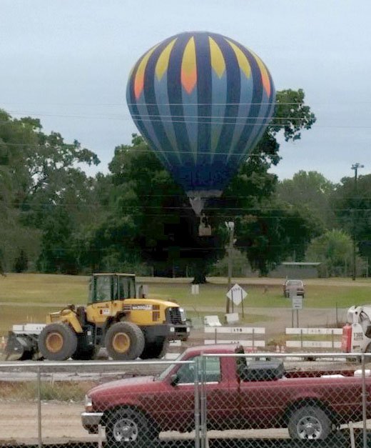 A hot air balloon believed to be the same one that later landed in a west Little Rock neighborhood takes off Friday, Aug. 21, 2015, from a lot just north of the Arkansas State Fairgrounds.