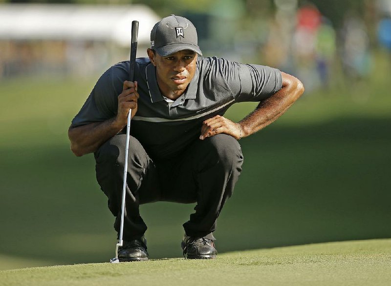 Tiger Woods lines up a putt on the 17th hole during the second round of the Wyndham Championship golf tournament in Greensboro, N.C., Friday, Aug. 21, 2015. 