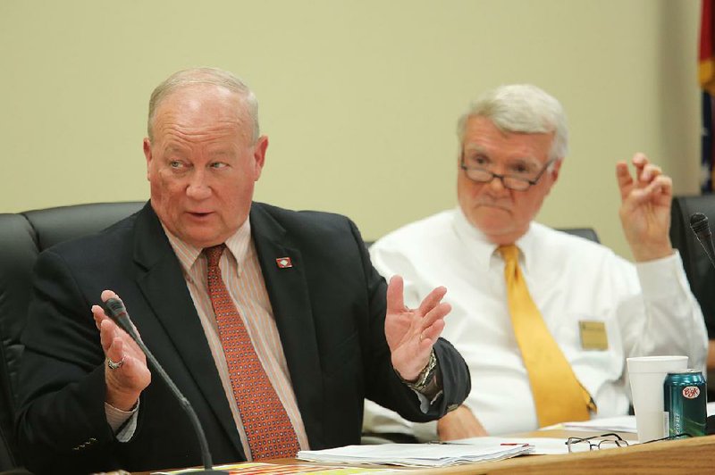 Arkansas Board of Corrections members John Felts (left) and Buddy Chadick discuss parole-revocation policies at a meeting Friday in Little Rock. 