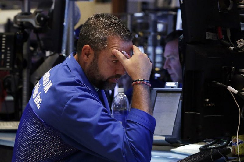 Trader Kevin Lodewick works on the floor of the New York Stock Exchange, where selling started early Friday and never let up. The Dow Jones industrial average fell 530.94 points. 