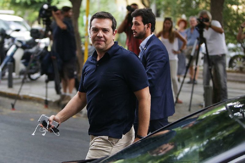 Greek Prime Minister Alexis Tsipras, who resigned Thursday, arrives Friday at his Syriza party’s headquarters in Athens. 