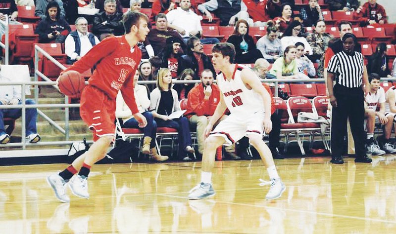 Drake Wilks, left, starts a dribble drive around a defender during a game from Wilks’ senior season at Benton Harmony Grove High School. Wilks, who stands 6-5, hopes  to draw attention from some major college programs by furthering his basketball skills at Elev8 Prep Academy in Florida. He will leave for Elev8 on Friday.