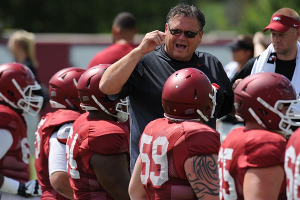 Arkansas offensive line coach Sam Pittman speaks Tuesday, Aug. 11, 2015, to members of his offensive line during practice at the university's practice field in Fayetteville.
