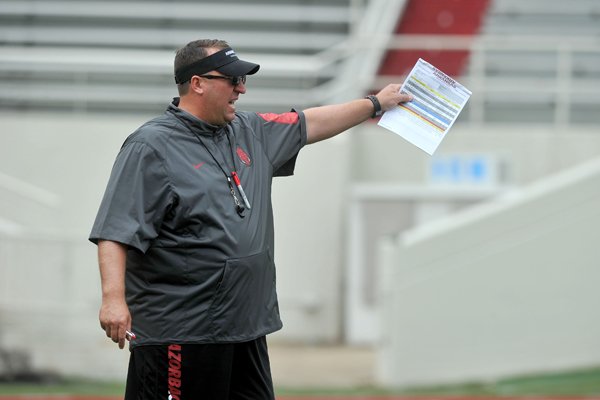 Arkansas coach Bret Bielema watches the Razorbacks run drills during practice Saturday, Aug. 22, 2015, at Razorback Stadium in Fayetteville.