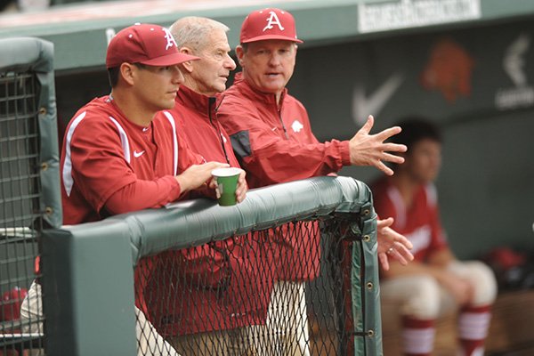 Former Arkansas coach Norm DeBriyn (left) speaks with current coach Dave Van Horn before the start of play against LSU Thursday, March 19, 2015, at Baum Stadium in Fayetteville.