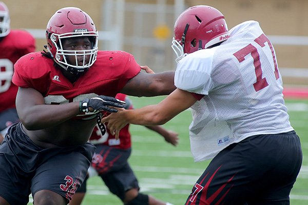 Hope defensive end McTelvin Agim (left) goes through practice on Thursday, Aug. 20, 2015, in Hope. 