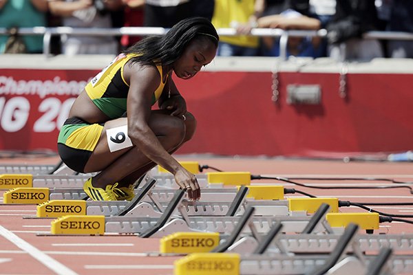 Jamaica's Veronica Campbell-Brown adjusts the starting blocks before women’s 100m round one at the World Athletics Championships at the Bird's Nest stadium in Beijing, Sunday, Aug. 23, 2015. (AP Photo/Andy Wong)