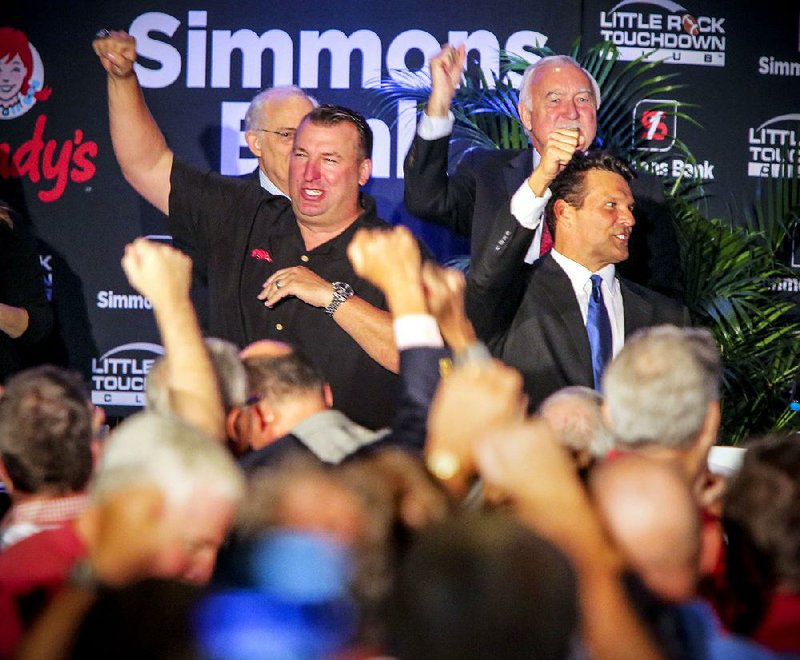 8/24/15
Arkansas Democrat-Gazette/STEPHEN B. THORNTON
Arkansas Coach Bret Bielema, left, Little Rock Touchdown Club founder David Bazzel, right, and others on stage call the hogs with country music star Justin Moore and the sell-out crowd during the Little Rock Touchdown Club meeting Monday in Little Rock.
