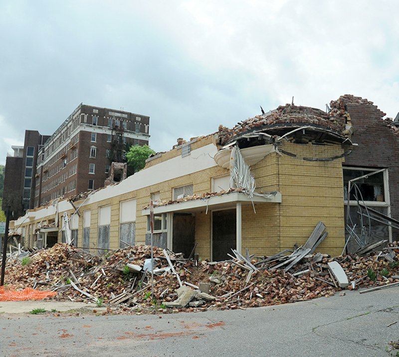 In this April 2015 photo, rubble from the sidewalk on the Park Avenue side of the Majestic Hotel is seen piled up after the "yellow brick building" portion of the hotel complex burned on Feb. 27, 2014.
