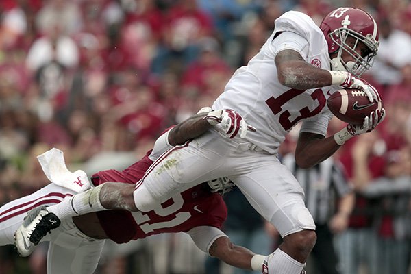 In this April 18, 2015, file photo, Alabama wide receiver ArDarius Stewart (13) catches a pass for a touchdown over Alabama defensive back Maurice Smith (21) during the first half of Alabama's spring NCAA college football game in Tuscaloosa, Ala. Alabama's receiving corps doesn't have an Amari Cooper this season, just a bunch of guys who were at least as highly recruited as the Heisman Trophy finalist. (AP Photo/Butch Dill, File)