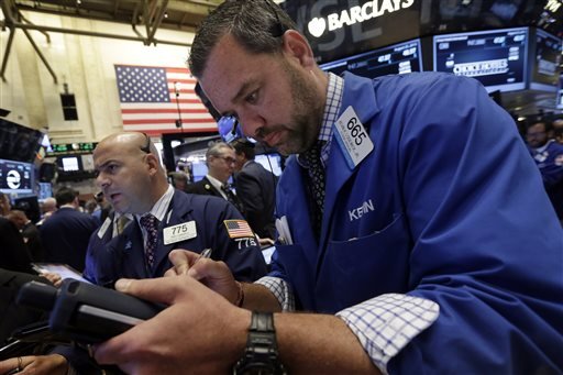 Traders Fred DeMarco, left, and Kevin Lodewick, right, work on the floor of the New York Stock Exchange, Tuesday, Aug. 25, 2015.