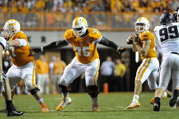 In this Aug. 31, 2014, file photo, Tennessee offensive lineman Marcus Jackson (75) provides pass protection during an NCAA college football game against Utah State in Knoxville, Tenn. Senior guard Marcus Jackson, the Vols’ most experienced offensive lineman, likely will miss the entire season with a biceps injury. (AP Photo/Knoxville News Sentinel, Michael Patrick, File)