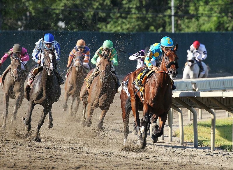 American Pharoah #4 with Victor Espinoza riding, leads the field around the final turn enroute to victory in the $1,750,000 Grade 1 William Hill Haskell Invitational at Monmouth Park in Oceanport, New Jersey on Sunday, Aug. 2, 2015. (Ryan Denver/EQUI-PHOTO via AP)