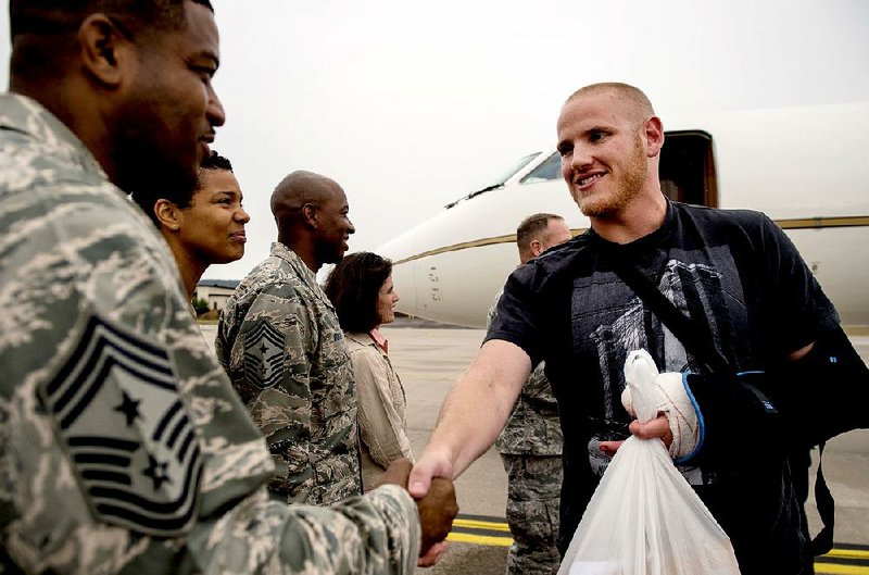 Air Force Airman 1st Class Spencer Stone (right), who helped thwart an attack on a Paris-bound train, meets Chief Master Sgt. Phillip Easton, 86th Airlift Wing command chief, upon his arrival at Ramstein Air Base, Germany, on Aug. 24, 2015.