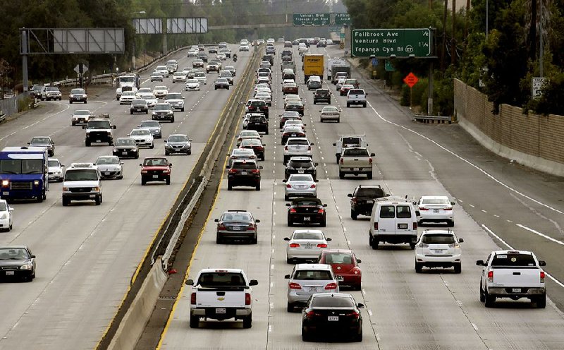 Cars move along the 101 Ventura Freeway near Topanga Canyon in Los Angeles on Tuesday. Traffic congestion is on the rise because of an improved economy, a report based on federal data shows.