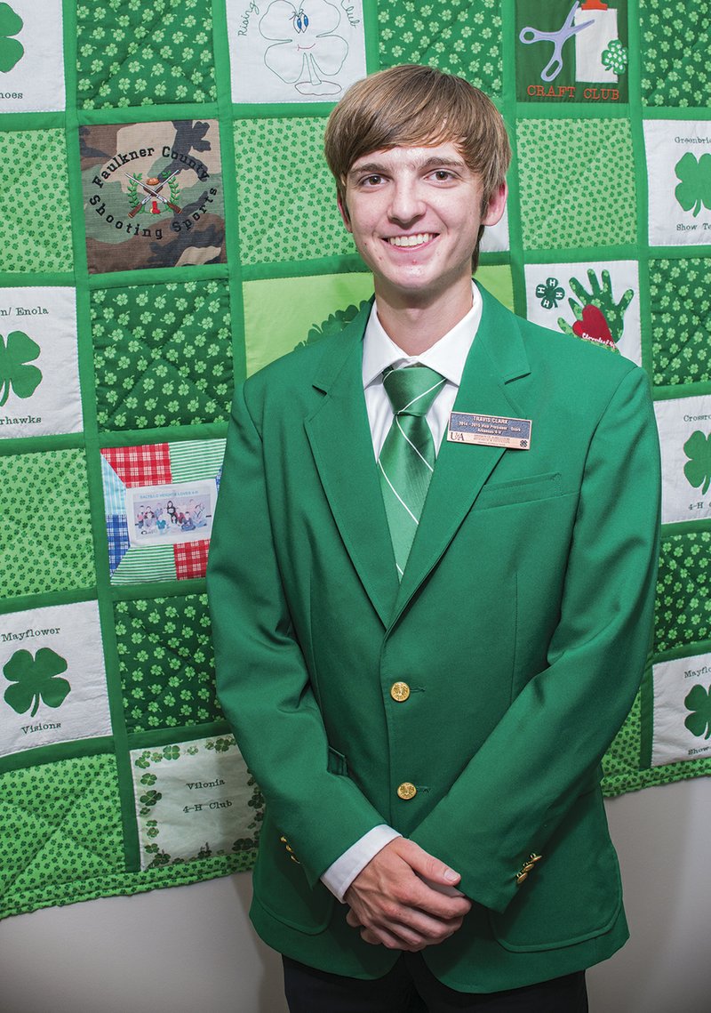 Travis Clark of El Paso, formerly of Vilonia, is the new president of Arkansas 4-H. Shown here in front of a 4-H quilt at the Faulkner County Cooperative Extension Service office in Conway, Clark will travel the state promoting 4-H and its motto, “To Make the Best Better.” The colors for 4-H are green and white. According to the 4-H handbook, green is nature’s most common color and represents youth, life and growth; white symbolizes purity and high ideals.