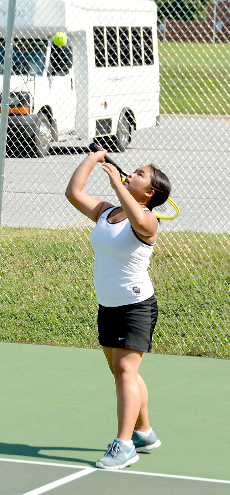 Graham Thomas/Herald-Leader Siloam Springs sophomore Valerie Lee serves during a junior varsity doubles match Monday against Shiloh Christian at the JBU Tennis Complex.