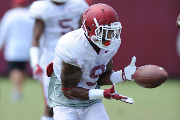 Arkansas defensive back Santos Ramirez catches a ball Thursday, Aug. 13, 2015, during practice at the university practice field in Fayetteville.