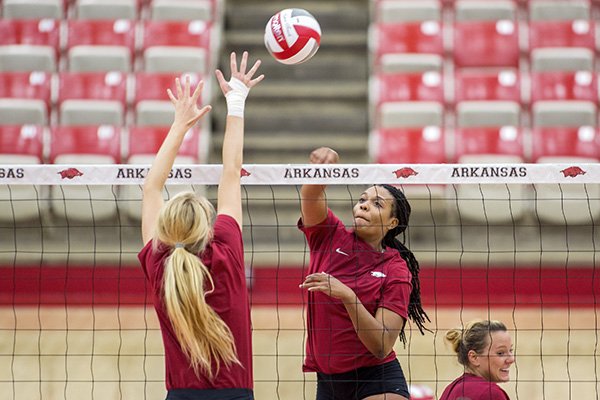 Senior Chanell Clark-Bibbs sends the ball over the net on Monday, Aug. 24, 2015, during practice inside Barnhill Arena in Fayetteville.