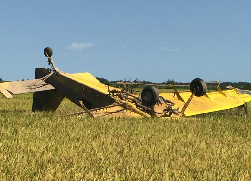 A single-engine crop duster flown by 44-year-old Robert Bobby Guthrie sits in a field after a crash Wednesday, Aug. 26, 2015. Guthrie suffered minor injuries in the crash.