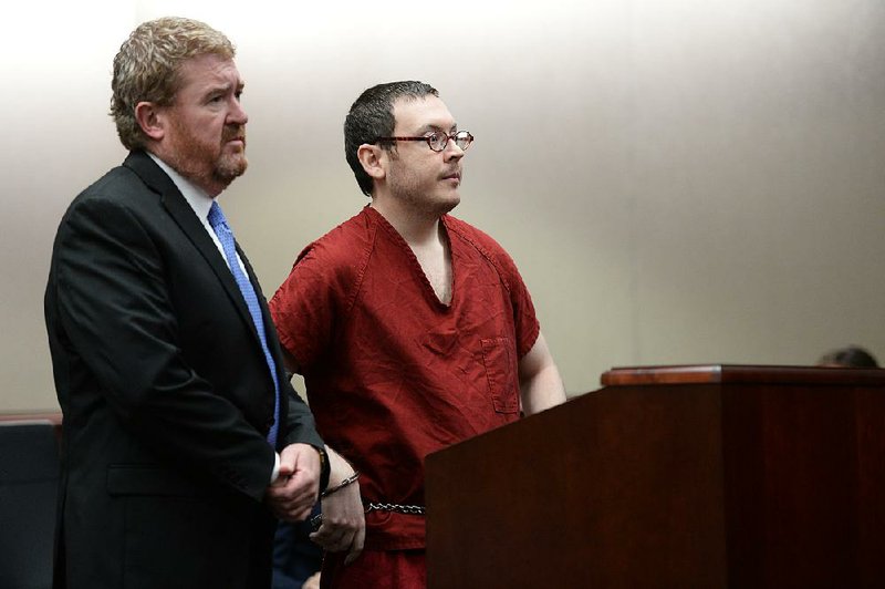 James Holmes stands in court Wednesday with his attorney Daniel King in Centennial, Colo., where he heard his sentence for the 2012 theater massacre.
